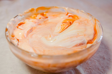 Fototapeta na wymiar mixing mayonnaise with ketchup in glass bowl