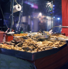 A food stall in a typical night market in Taipei with Tofu and chicken meat snacks
