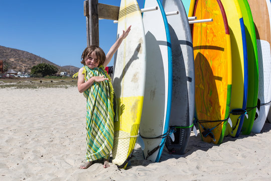 5 year old boy posing with multi-colored surf boards, Cerritos Beach, Todos Santos