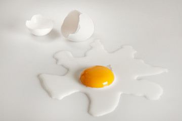 Broken egg on white background (selective focus)