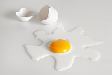 Broken egg on white background (selective focus)