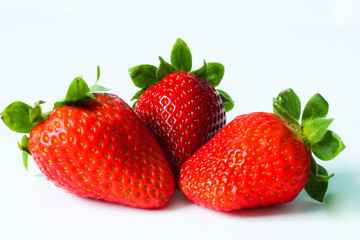 Group of fresh, juicy strawberries close up, selective focus, white background