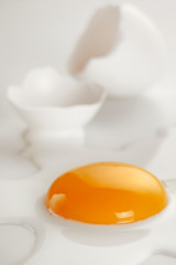 Broken egg on white background (selective focus)