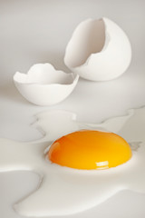 Broken egg on white background (selective focus)