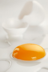 Broken egg on white background (selective focus)