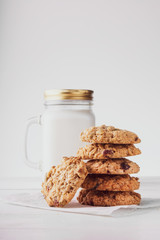 oatmeal cookies with milk on a light background