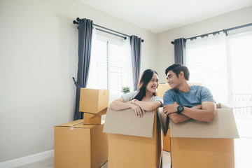 Happy young couple enjoying together moving in a new house.