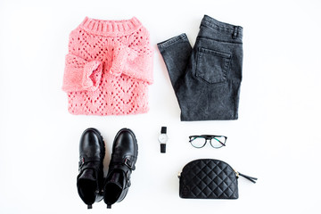 Women fashion clothes and accessories. Feminine youth collage on white background top view. Flat lay female style look with warm sweater, jeans, boot, glasses. Top view.