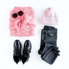 Women fashion clothes and accessories. Feminine youth collage on white background top view. Flat lay female style look with warm sweater, jeans, boot, glasses. Top view.