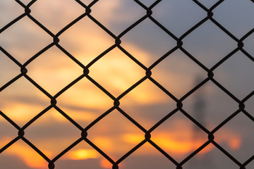 Fototapeta premium Metal cage square channel on beautiful sunset nature background
