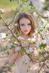 Sensual close up portrait of a spring girl, beautiful face female enjoying spring  blossom, dreamy girl with White fresh flowers outdoor, seasonal nature, tree branch and glamorous lady