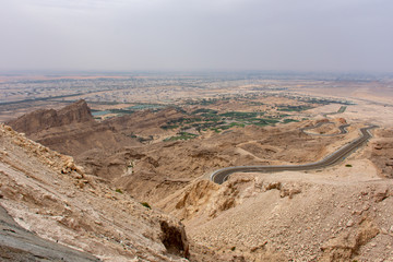 Viewpoint of twisted highway on Jebal Hafeet and City (aka Jebel Hafit) in Al Ain, UAE.