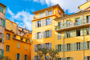 Fototapeta premium Nice, France, colorful facade, with typical windows, balconies and shutters 