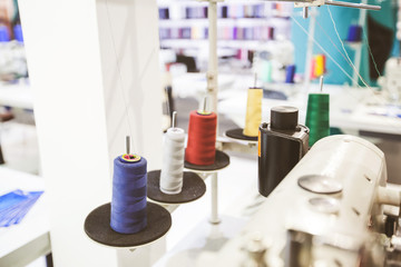 Colorful sewing threads spools at textile workshop