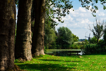 ditch with tree trunks and mill, at Fort Altena, Werkendam, The Netherlands
