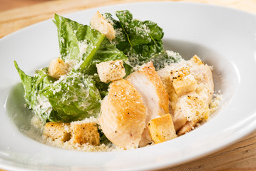 fresh caesar salad in the white plate