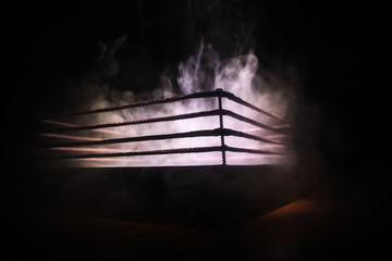 Empty boxing ring with red ropes for match in the stadium arena. Creative artwork decoration