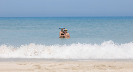 Fototapeta na wymiar guy and girl are swimming on the beach