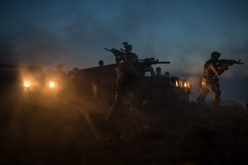Fototapeta na wymiar War Concept. Military silhouettes fighting scene on war fog sky background, Fighting silhouettes Below Cloudy Skyline At night. Battle scene. Army vehicle with soldiers. army