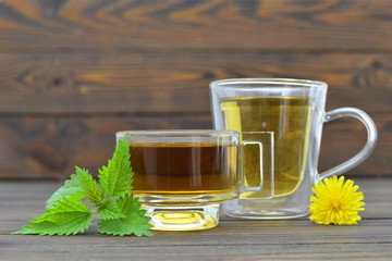 Herbal tea in transparent cups on wooden table