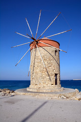 Fototapeta na wymiar Windmill in cost in city Rhodes