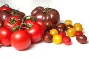 group of various tomatoes en white background