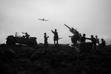 An anti-aircraft cannon and Military silhouettes fighting scene on war fog sky background. Allied...