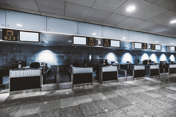 View of a check-in area in a contemporary airport: luggage accept terminals with baggage handling...