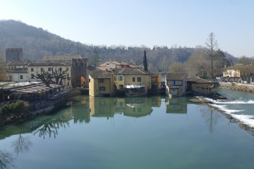 Fototapeta na wymiar panorama of Medieval village of Borghetto on Mincio river from the Roman bridge
