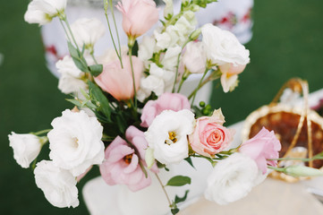 Beautiful and colorful bouqut of pink and white roses on wedding table