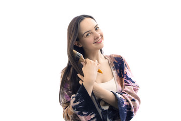 Portrait happy artist painter posing and smiling with brush in a studio. Creative painter girl, isolated on white