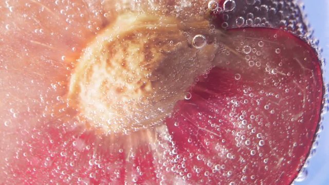 plum closeup in water juicy fruit bubbles under water