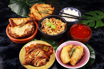 Assorted Chinese food set. Chinese noodles, fried rice, peking duck, dim sum, spring rolls. Famous Chinese cuisine dishes on table. Chinese restaurant concept. 