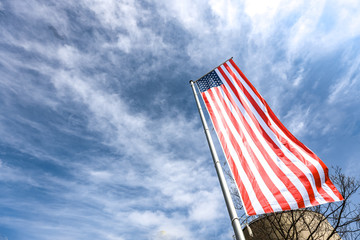 American flag on a sunny day under blue sky