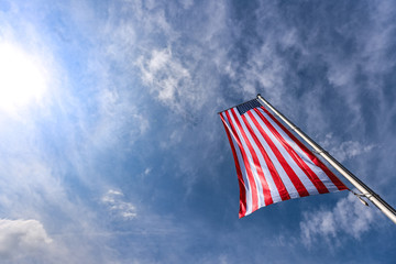 American flag on a sunny day under blue sky