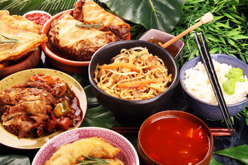 Assorted Chinese food set. Chinese noodles, fried rice, peking duck, dim sum, spring rolls. Famous Chinese cuisine dishes on table. Chinese restaurant concept. 