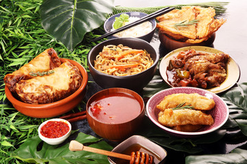 Assorted Chinese food set. Chinese noodles, fried rice, peking duck, dim sum, spring rolls. Famous Chinese cuisine dishes on table. Chinese restaurant concept. 
