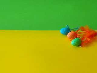 Easter eggs on green and yellow background, place for text