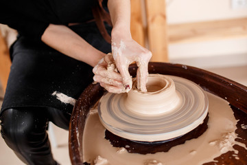Hands sculpt new utensil on a pottery wheel