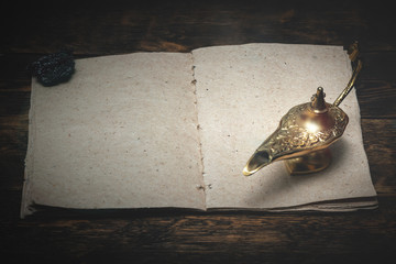 A Wish list mock up and a golden Genie lamp on a wooden board background. Fulfillment of desires...