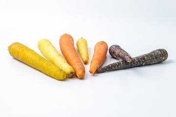colourful organic carrots on white background 