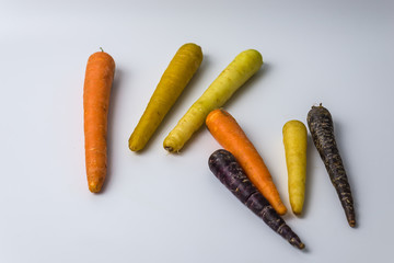 colourful organic carrots on white background 