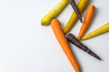 colourful organic carrots on white background 