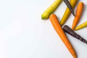 colourful organic carrots on white background 