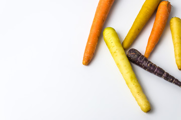 colourful organic carrots on white background 