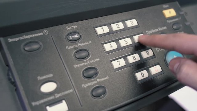 The worker performs work on industrial equipment by pressing the control buttons, which light up