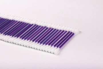 purple cotton buds on a white background