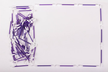 pile of purple cotton buds on white background, copy space