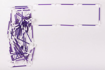 pile of purple cotton buds on white background, copy space