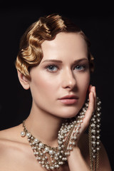 Vintage style portrait of beautiful blonde woman with fancy prom hairdo